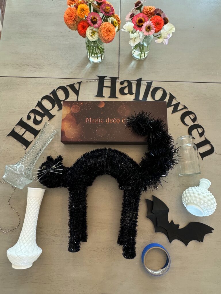 black cat, thrifted vases, bats and hanging candles to decorate the stir and gather blog mantel