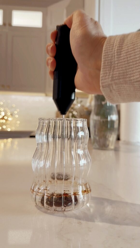 stir and gather adding date syrup to a glass