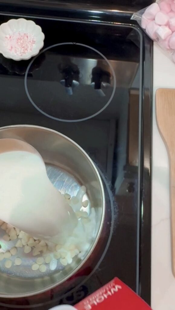 stir and gather adding milk to peppermint white hot chocolate