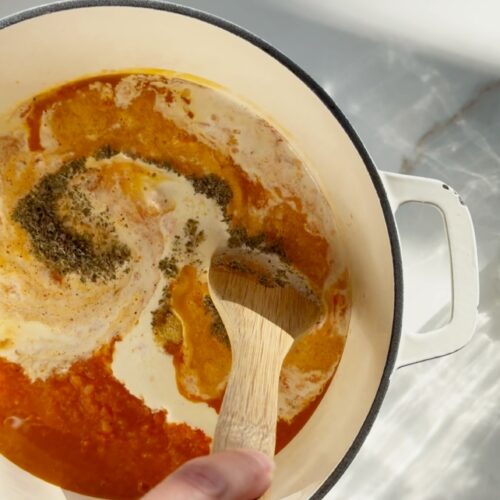 stir and gather making sheet pan tomato soup in a cast iron dutch oven