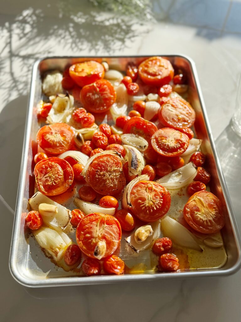 stir and gather roasting tomatoes for sheet pan tomato soup