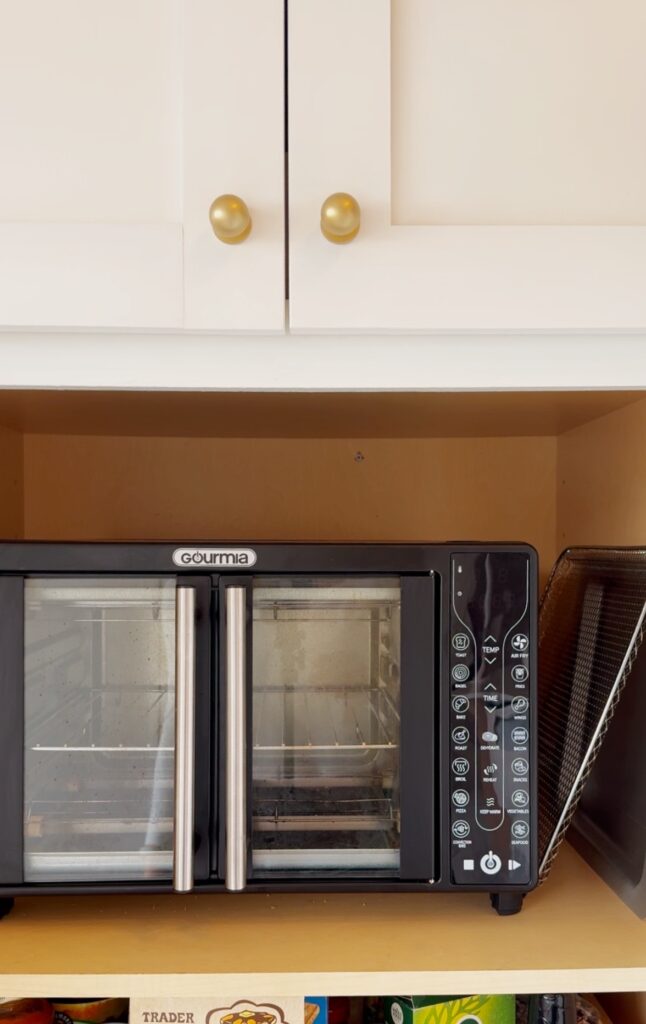 stir and gathers air fryer within the cabinet
