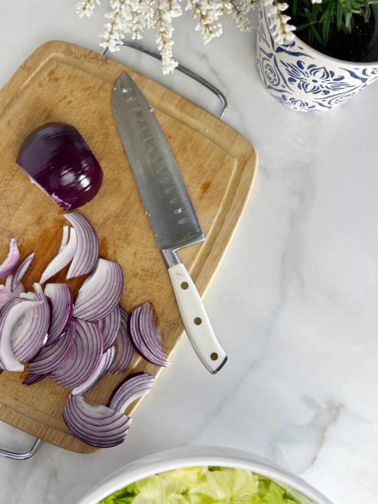 stir and gather chopping onions for viral La Scala salad