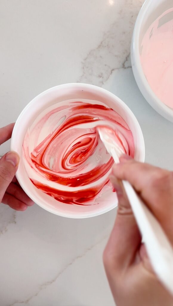 stir and gather adding food coloring to meringue