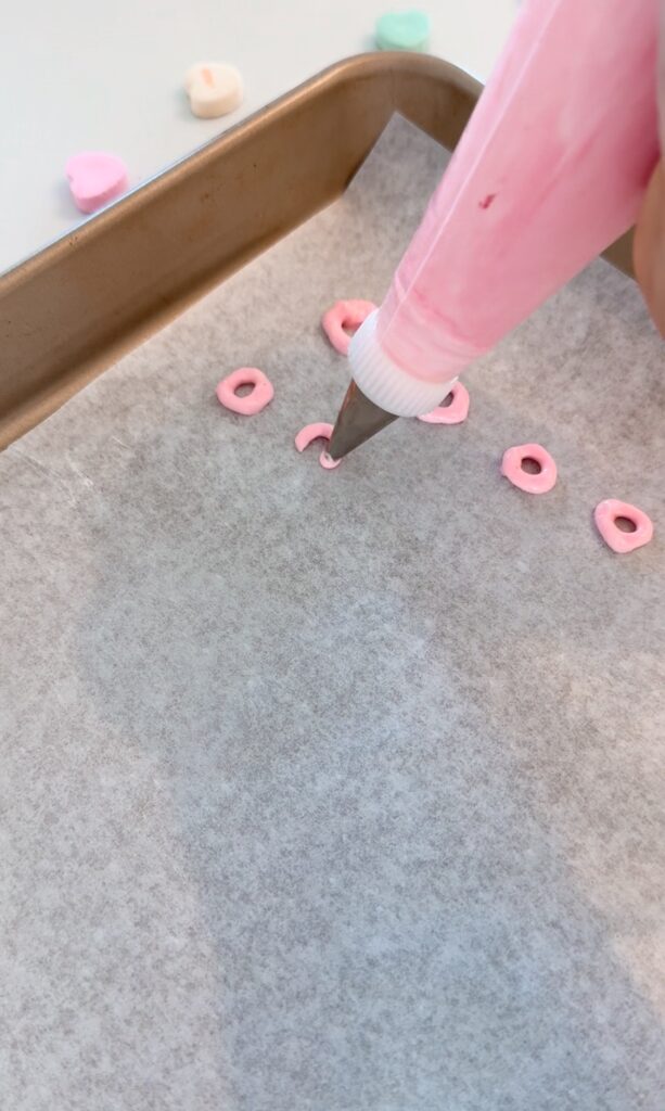 stir and gather piping out meringue onto a cookie sheet
