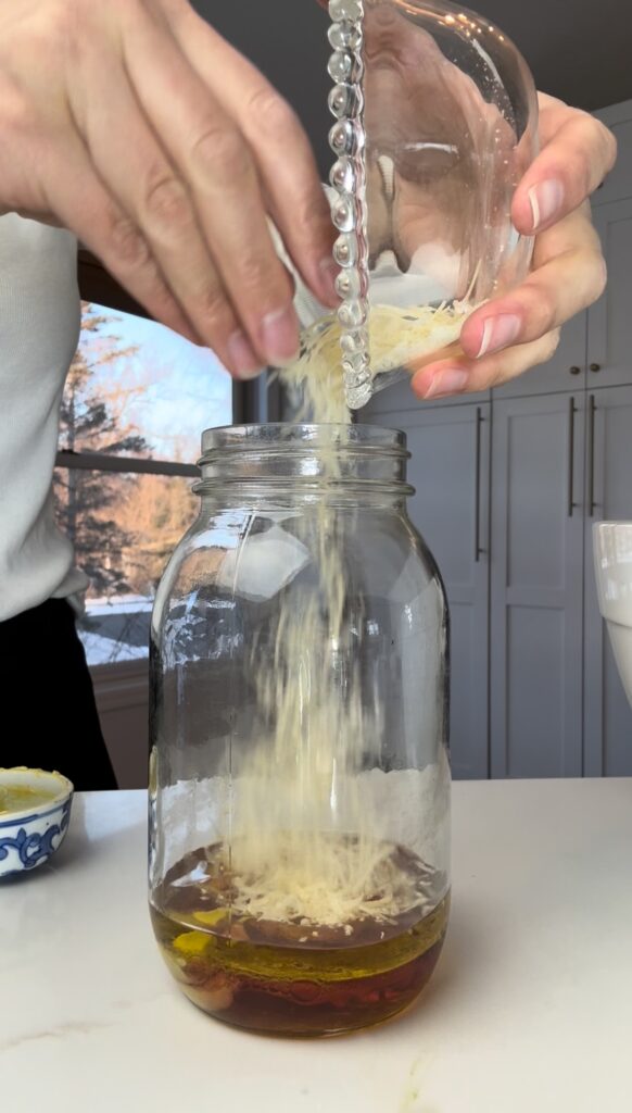 stir and gather adding Parmesan to dressing for La Scala salad