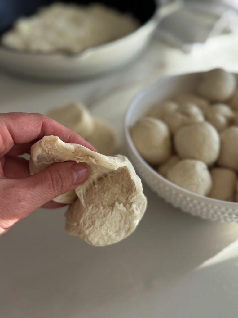 stir and gather making ball shaped biscuits for pizza dip