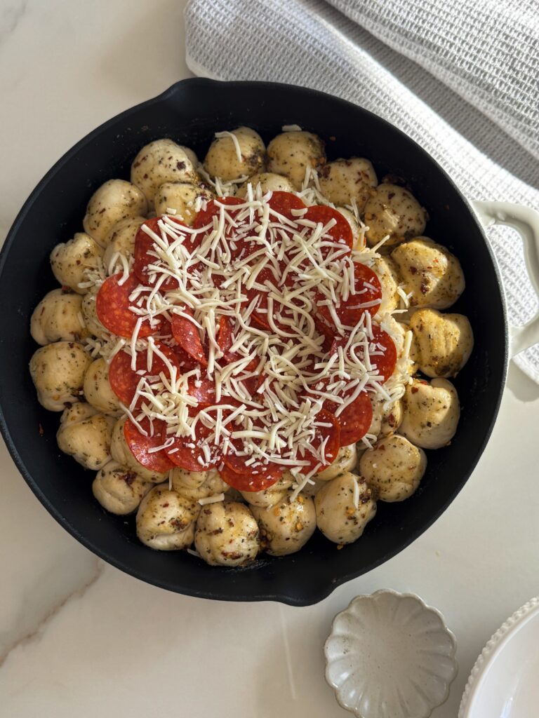 stir and gather adding toppings to pizza dip